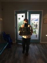 Carrying a pyramid of boxes.